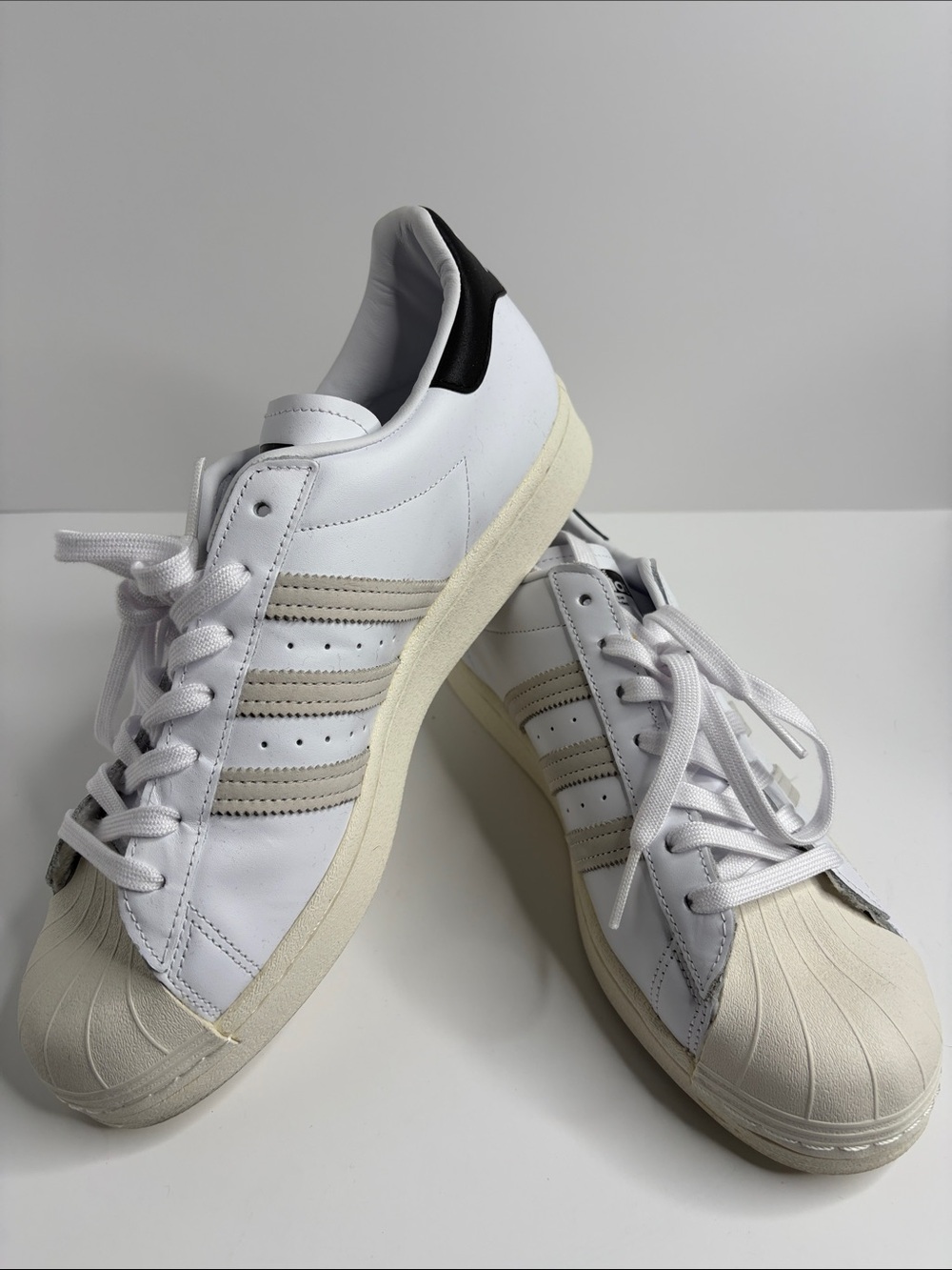 Adidas White Superstar Sneakers with Beige Stripes and Black Heel Accent FV2808